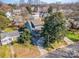 Aerial view of a home with a welcoming front porch, mature trees, and a neatly kept lawn at 130 N Smallwood Pl, Charlotte, NC 28216