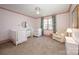 Bright bedroom features pastel pink accents, a ceiling fan, and two bassinets at 130 N Smallwood Pl, Charlotte, NC 28216