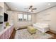 Bonus room features a ceiling fan, large windows, and a seating area with a sofa at 130 N Smallwood Pl, Charlotte, NC 28216