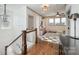 Hallway with staircase that leads to an open room with neutral paint and plenty of natural light at 130 N Smallwood Pl, Charlotte, NC 28216
