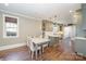 Well-lit kitchen and dining area featuring hardwood floors and modern appliances at 130 N Smallwood Pl, Charlotte, NC 28216