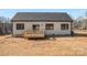 The backyard features a small wooden deck and a large, level lawn area perfect for outdoor activities at 1313 Springdale Park Dr, Lincolnton, NC 28092