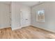 Bedroom featuring wood-look flooring, a large window, and closet with double doors at 1313 Springdale Park Dr, Lincolnton, NC 28092