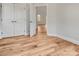 Bedroom featuring wood-look flooring and a view into another room via an open white door at 1313 Springdale Park Dr, Lincolnton, NC 28092