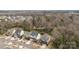 Aerial view of homes on tree-lined street with wooded area behind the houses at 13725 Laughing Gull Dr, Charlotte, NC 28278