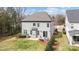 Aerial backyard view features outdoor seating area, grill, green lawn, and mature landscaping at 13725 Laughing Gull Dr, Charlotte, NC 28278