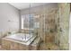 Bathroom featuring a large soaking tub and a tiled shower with a glass door at 13725 Laughing Gull Dr, Charlotte, NC 28278