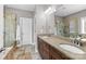 Bathroom featuring dual sinks, vanity, and a large tiled shower with glass door at 13725 Laughing Gull Dr, Charlotte, NC 28278