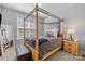 Cozy bedroom with four-poster bed, plush bedding, and ample natural light at 13725 Laughing Gull Dr, Charlotte, NC 28278