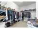 Walk-in closet with rods, shelves, and organized clothing and shoes at 13725 Laughing Gull Dr, Charlotte, NC 28278