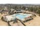 Aerial view of community pool area features a pool, a playground, and covered seating at 13725 Laughing Gull Dr, Charlotte, NC 28278