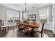Elegant dining room features wood floors, wainscoting, and large windows for natural light at 13725 Laughing Gull Dr, Charlotte, NC 28278