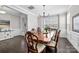 Spacious dining room boasts wood floors, wainscoting, and stylish light fixture at 13725 Laughing Gull Dr, Charlotte, NC 28278