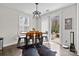 Bright dining area features wood floors, modern light fixture, and sliding glass doors leading to outdoor patio at 13725 Laughing Gull Dr, Charlotte, NC 28278