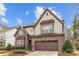 Charming two-story home boasts stone accents, a two-car garage, and a well-manicured front yard at 13725 Laughing Gull Dr, Charlotte, NC 28278