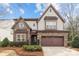 Beautiful two-story home features stone accents, a two-car garage, and manicured landscaping at 13725 Laughing Gull Dr, Charlotte, NC 28278