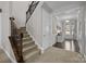 Bright foyer view with stairs, hardwood floors, and a stylish accent table with decor at 13725 Laughing Gull Dr, Charlotte, NC 28278