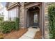 Inviting front entrance with stone accents, a covered porch, and a well-lit pathway at 13725 Laughing Gull Dr, Charlotte, NC 28278