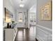 Inviting hallway with wood floors, elegant console table, and view into adjoining rooms at 13725 Laughing Gull Dr, Charlotte, NC 28278