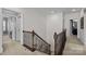 Hallway with railing featuring carpet and access to rooms with doors at 13725 Laughing Gull Dr, Charlotte, NC 28278