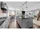 Open-concept kitchen featuring a large island, stainless steel appliances, and seamless flow to the living area at 13725 Laughing Gull Dr, Charlotte, NC 28278