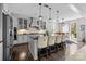 Spacious kitchen with gray cabinets, a large island with seating, and modern pendant lighting at 13725 Laughing Gull Dr, Charlotte, NC 28278