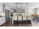 Bright kitchen with gray cabinetry, a large island with seating, and a view of the dining area at 13725 Laughing Gull Dr, Charlotte, NC 28278