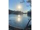 Beautiful lake view with shimmering reflections of the sun and blue sky on a clear day at 13725 Laughing Gull Dr, Charlotte, NC 28278