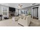 Relaxing living room features stone fireplace, neutral furnishings, and open floor plan at 13725 Laughing Gull Dr, Charlotte, NC 28278