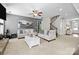 Comfortable living room features neutral colors, plush seating, and elegant stairway at 13725 Laughing Gull Dr, Charlotte, NC 28278