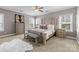 Spacious main bedroom features neutral walls, plush bedding, and dual windows for natural light at 13725 Laughing Gull Dr, Charlotte, NC 28278