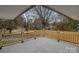 Corner view from a concrete backyard patio featuring a wooden fence and mature trees at 1601 Mooresville Rd, Salisbury, NC 28147