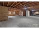 Unfinished basement offering exposed ceiling and ample room for customization at 1601 Mooresville Rd, Salisbury, NC 28147