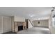 Spacious finished basement with a stone fireplace, painted brick accents, and walk-out access at 1601 Mooresville Rd, Salisbury, NC 28147