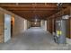Unfinished basement with exposed ceiling, storage, and water heater, ready for personalization at 1601 Mooresville Rd, Salisbury, NC 28147