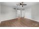 Open bedroom with hardwood floors, connecting to a sliding barn door, closet, and bathroom at 1601 Mooresville Rd, Salisbury, NC 28147