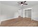 Bedroom with hardwood floors, natural lighting, a ceiling fan, and a walk-in closet at 1601 Mooresville Rd, Salisbury, NC 28147
