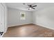 This bedroom is spacious and features hardwood floors, a ceiling fan, and natural light from a window at 1601 Mooresville Rd, Salisbury, NC 28147