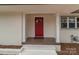 This entry offers a bright red door, well lit entryway and brick exterior at 1601 Mooresville Rd, Salisbury, NC 28147