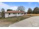 This home boasts a well-kept lawn, brick walkway and a white brick exterior with a new fence at 1601 Mooresville Rd, Salisbury, NC 28147