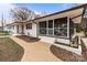 Charming screened-in porch complements this home's white brick exterior and well-maintained landscaping at 1601 Mooresville Rd, Salisbury, NC 28147