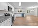Bright kitchen with stainless steel appliances, modern fixtures, granite countertops, and hardwood floors at 1601 Mooresville Rd, Salisbury, NC 28147