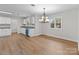 Eat-in kitchen with hardwood floors, stainless steel appliances, granite countertops, and an open dining area at 1601 Mooresville Rd, Salisbury, NC 28147