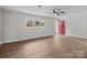 Bright living room with stylish wood flooring, fireplace, neutral paint, and a large window at 1601 Mooresville Rd, Salisbury, NC 28147
