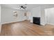Living room featuring a fireplace, hardwood floors, with a window and glass front door that provides natural light at 1601 Mooresville Rd, Salisbury, NC 28147