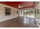 Screened-in porch with ceiling fan provides an inviting outdoor living space with a red ceiling at 1601 Mooresville Rd, Salisbury, NC 28147