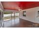 Screened-in porch with ceiling fan is perfect for relaxing or entertaining with a red ceiling at 1601 Mooresville Rd, Salisbury, NC 28147