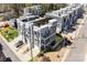 Aerial view of modern townhomes with individual garages, rooftop balconies, and modern architecture at 1659 Duckworth Ave, Charlotte, NC 28208