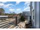 Upstairs balcony with modern railings, outdoor furniture and views of neighborhood at 1659 Duckworth Ave, Charlotte, NC 28208