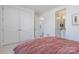 Bright bedroom featuring a closet, ensuite bathroom, and a blush colored bedspread at 1659 Duckworth Ave, Charlotte, NC 28208